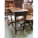 An early 20th century oak occasional table, the top over end drawer on barley twist legs