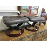 A pair of brown leatherette upholstered stools