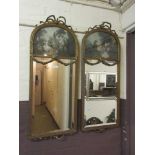 A pair of gilt framed and swag decorated pictorial bevel mirrors (A/F) Losses to bows and top of one