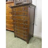 An early 20th century music cabinet comprising of eight drawers with fall fronts