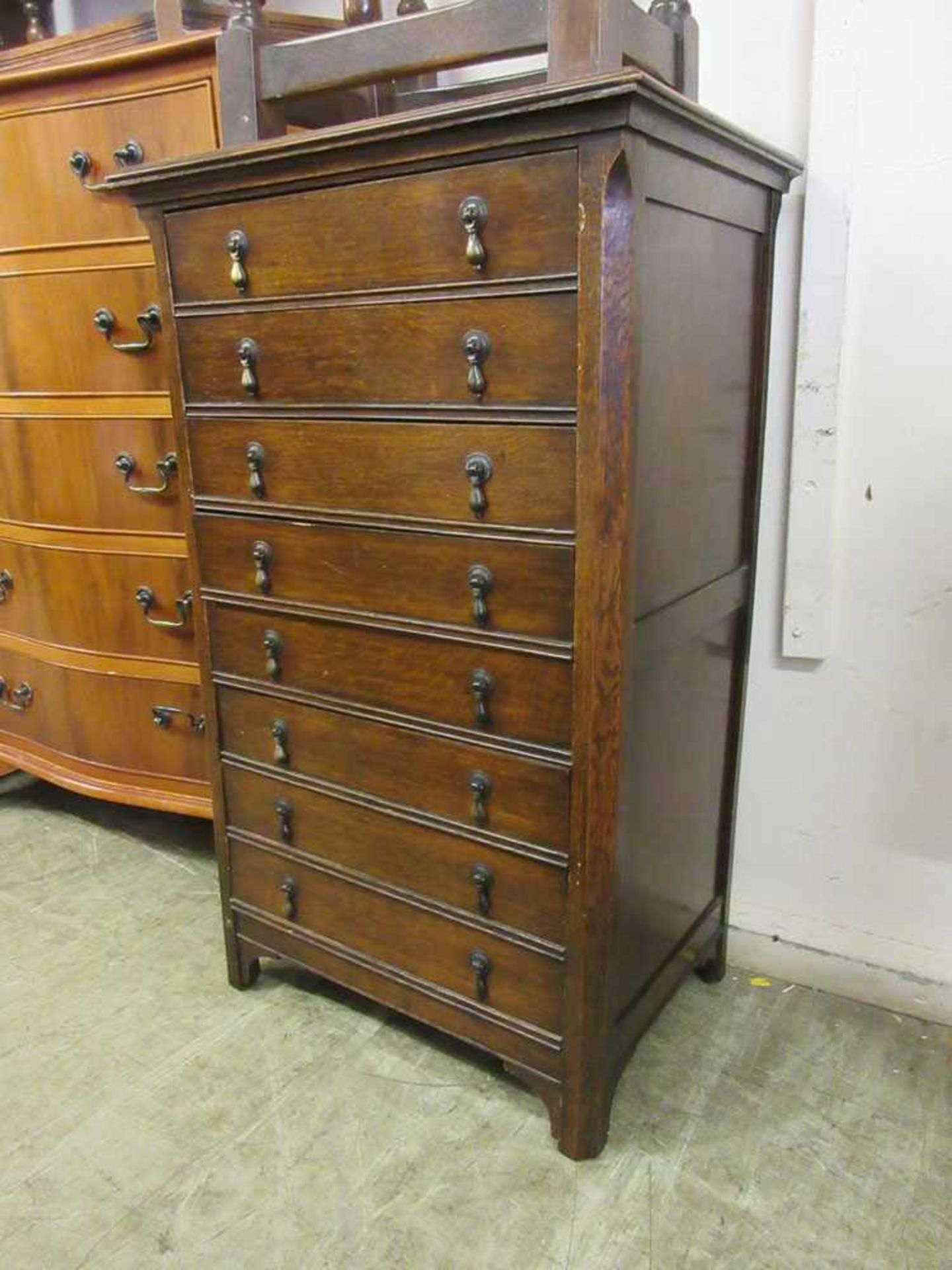 An early 20th century music cabinet comprising of eight drawers with fall fronts