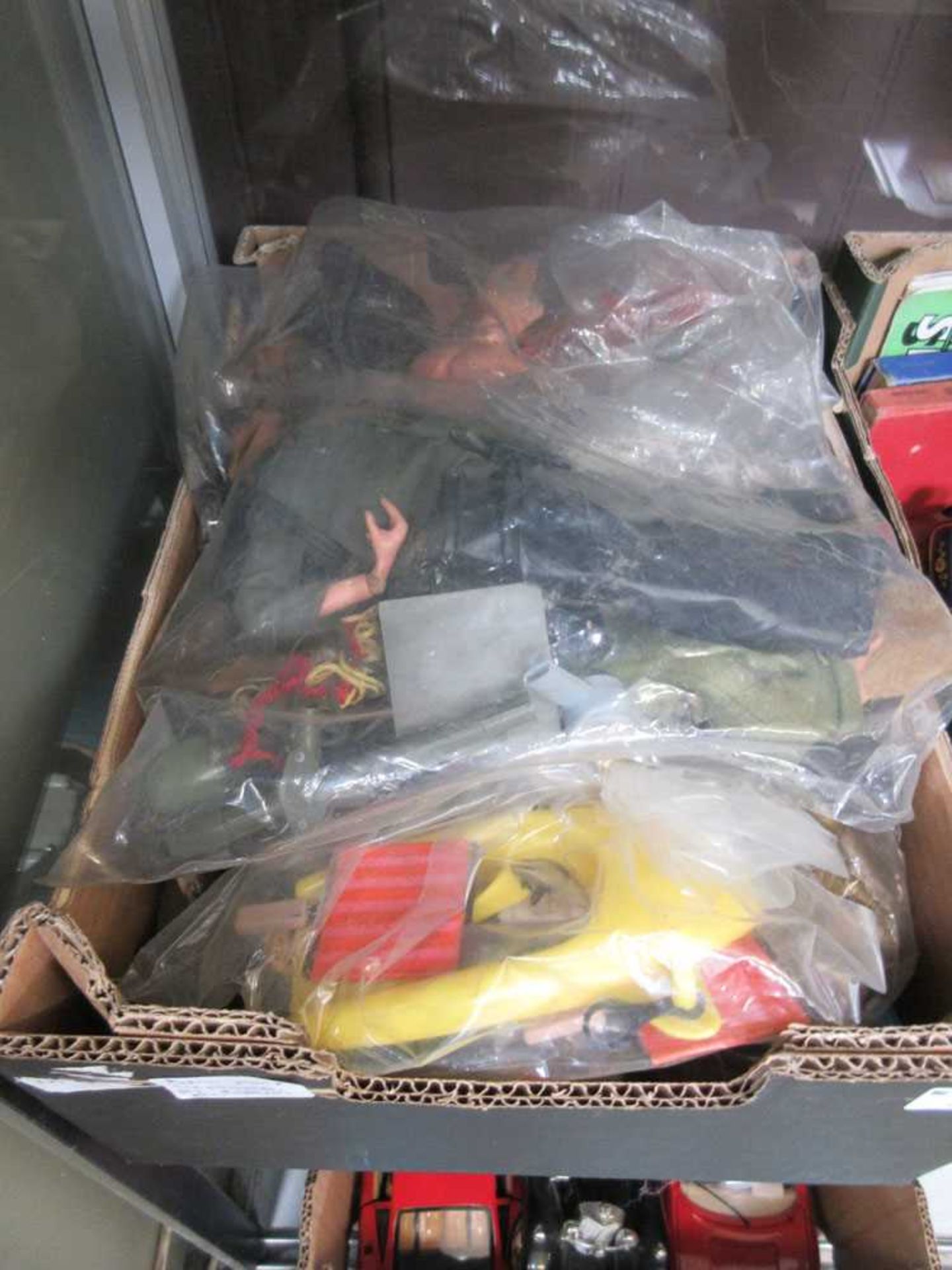 A box containing a quantity of Action Man figures and accessories