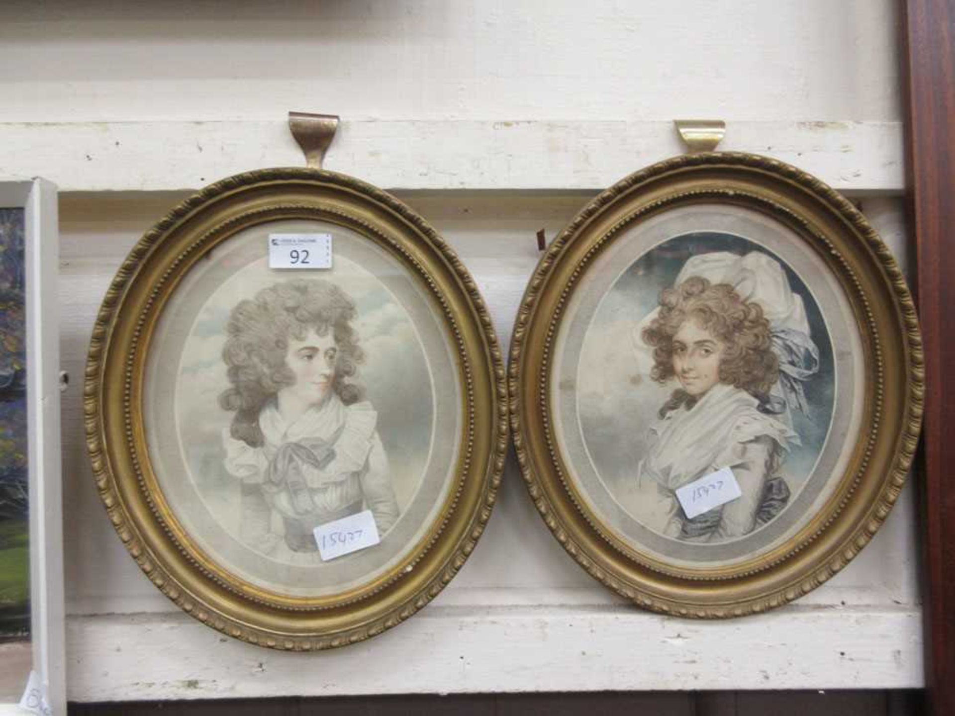 A pair of gilt framed and glazed oval prints of people