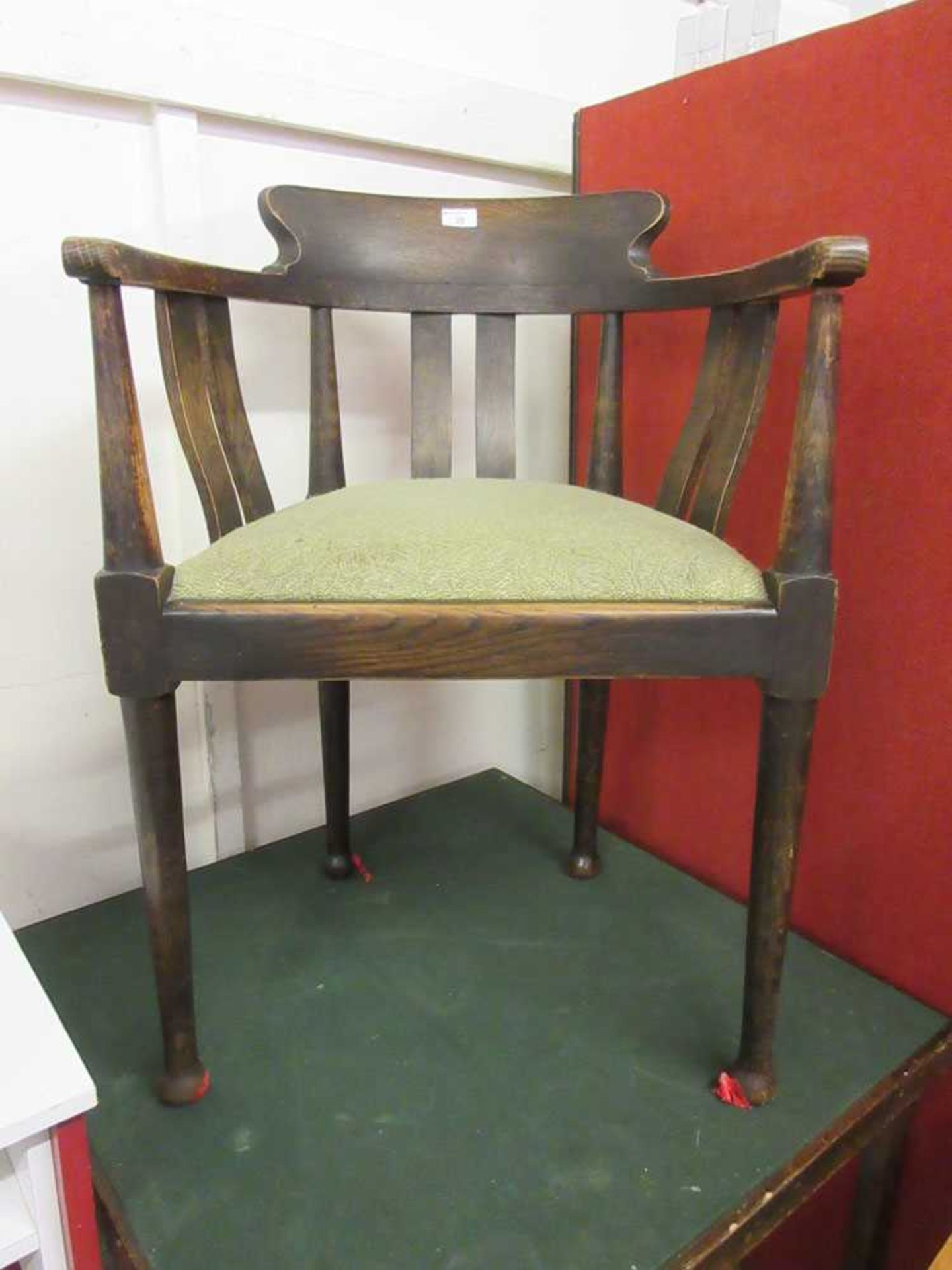 An early 20th century oak armchair on turned legs