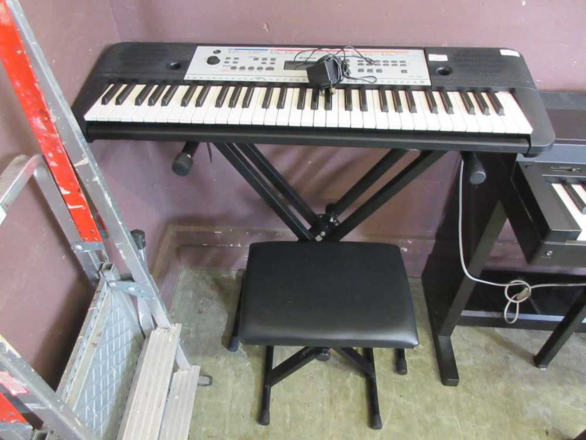 A Yamaha YPT-260 keyboard on stand with stool