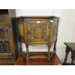 An Old Charm oak side cabinet with linen fold Roman arch panels