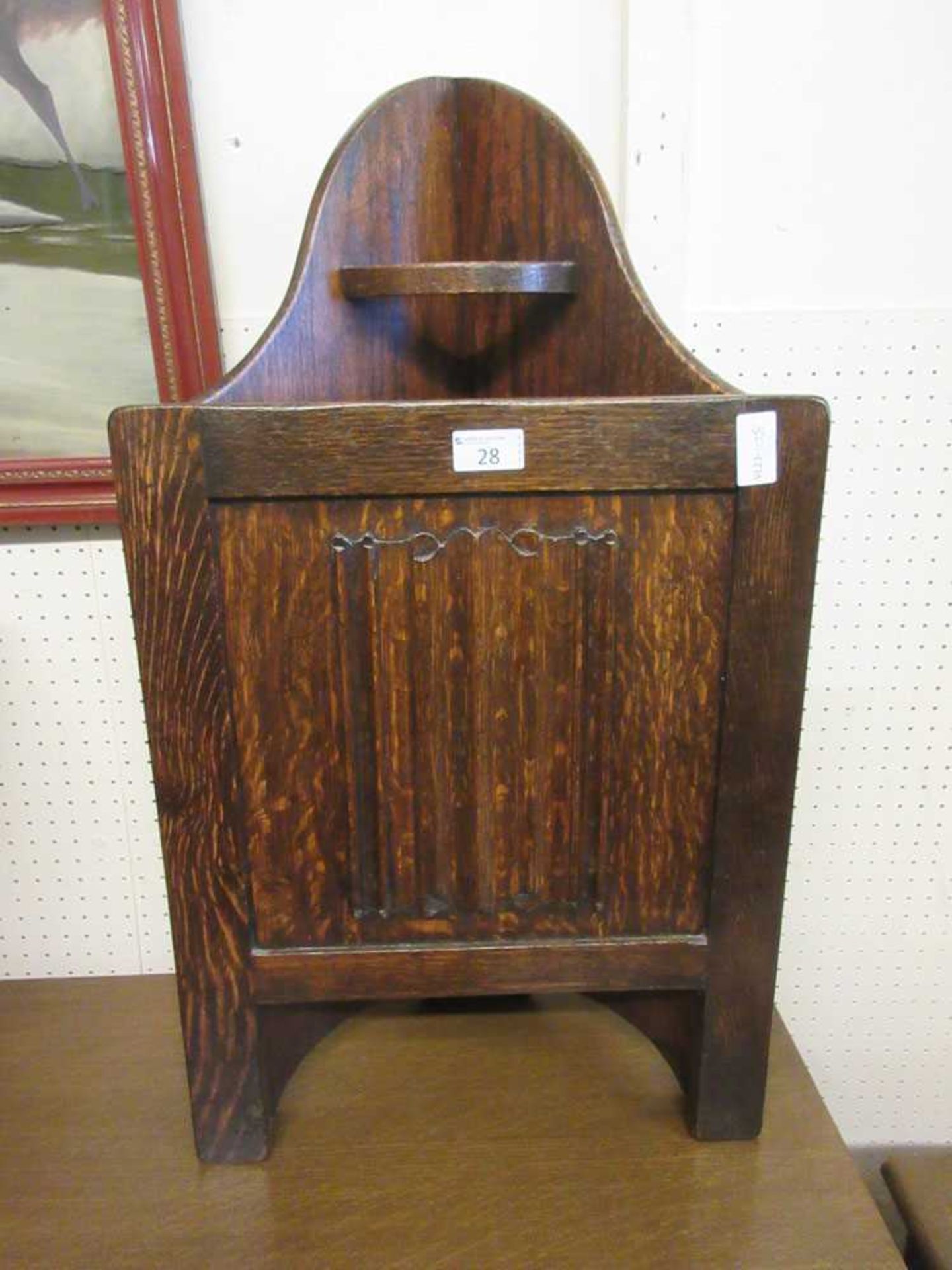 An early 20th century oak corner stick stand with linen fold panel