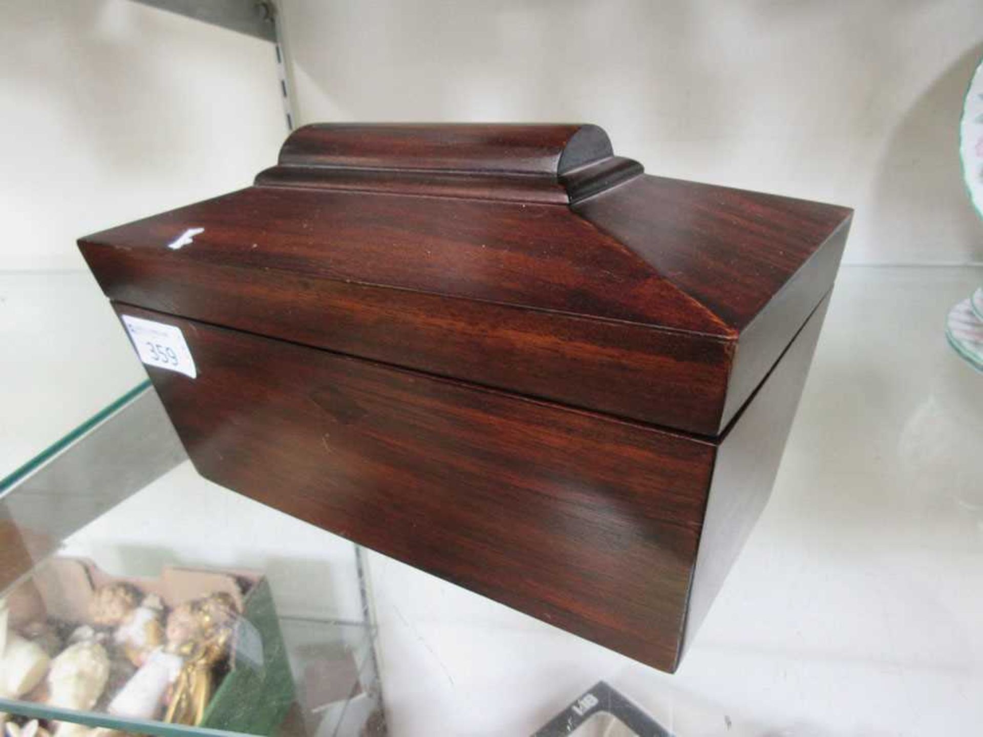 An early 19th century mahogany sarcophagus tea caddy