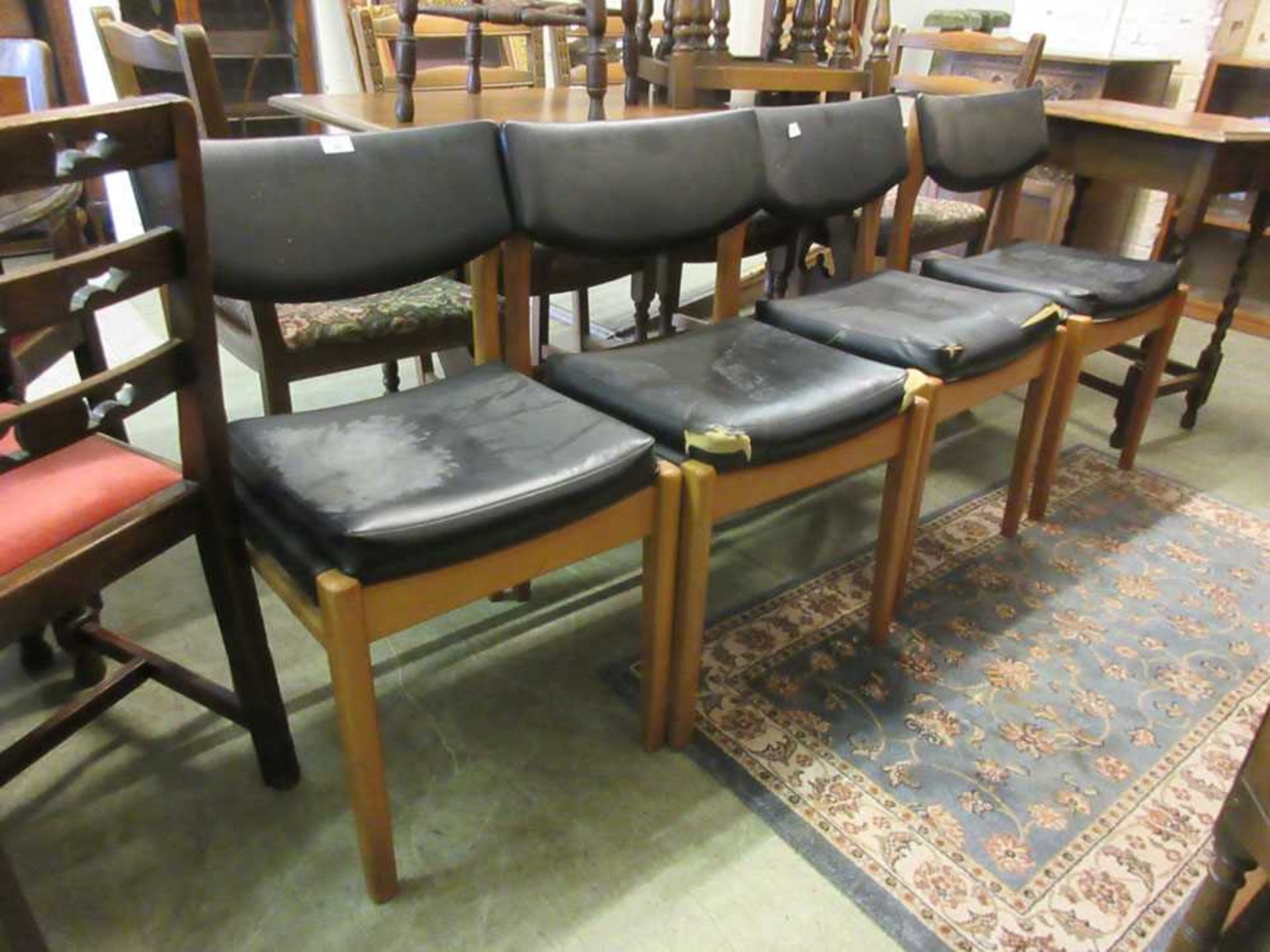 A set of four beech framed and Rexine upholstered dining chairs (A/F)