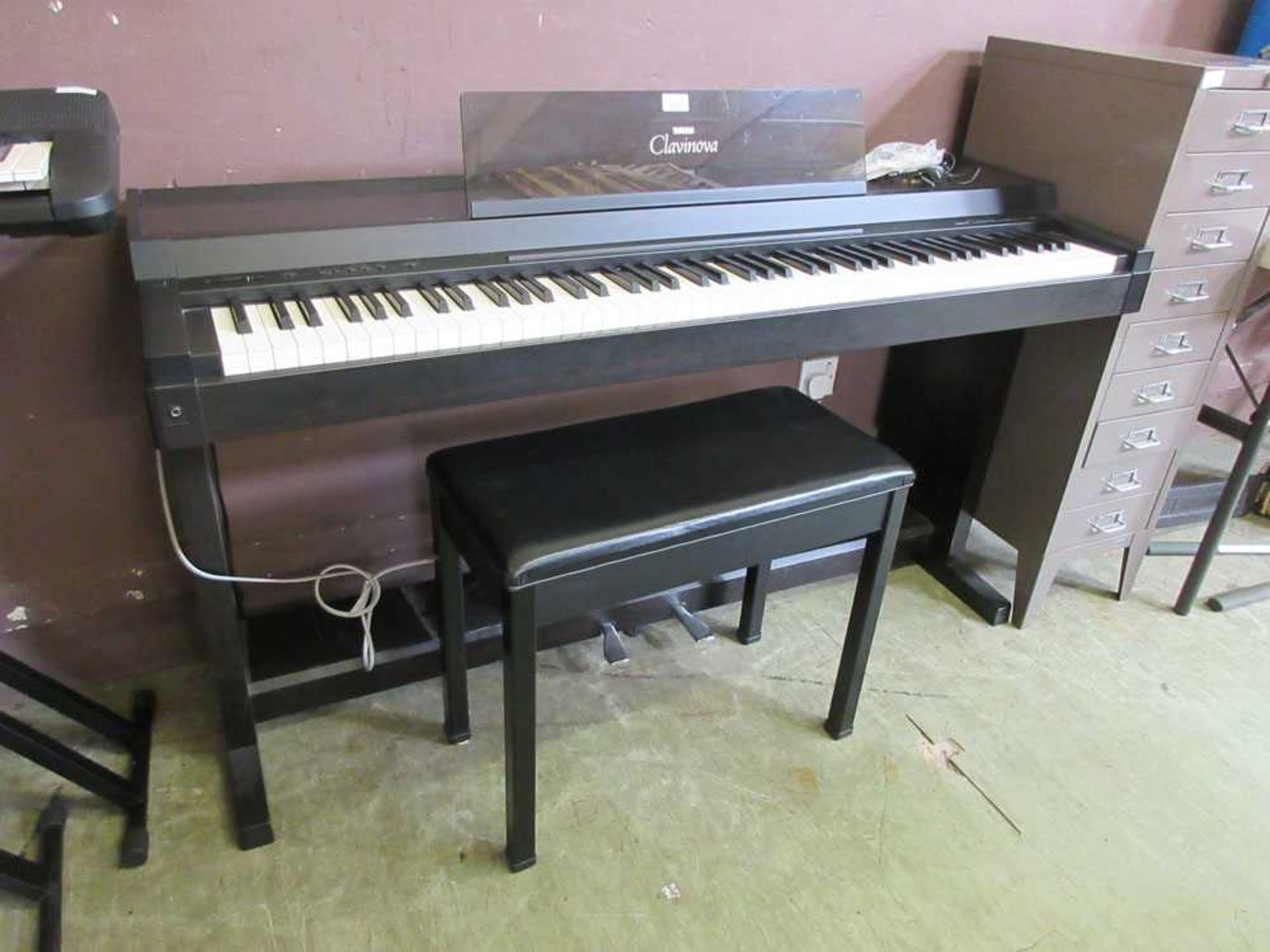 A Yamaha Clavinova CLP-300 keyboard on stand with stool