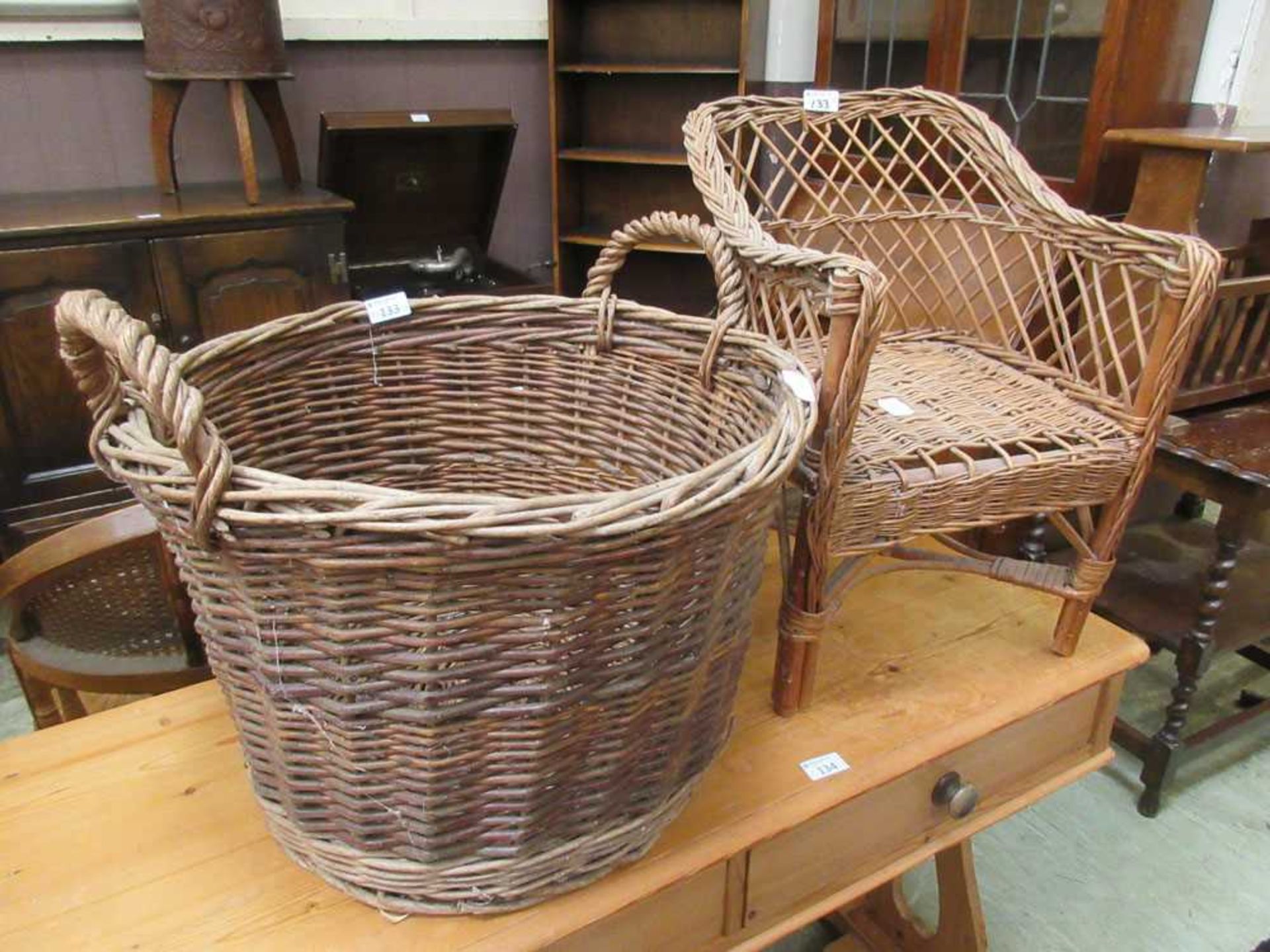 A wickerwork log basket along with a wickerwork child's chair