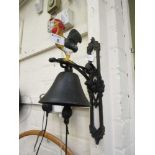 A cast iron wall hanging bell with cockerel finial