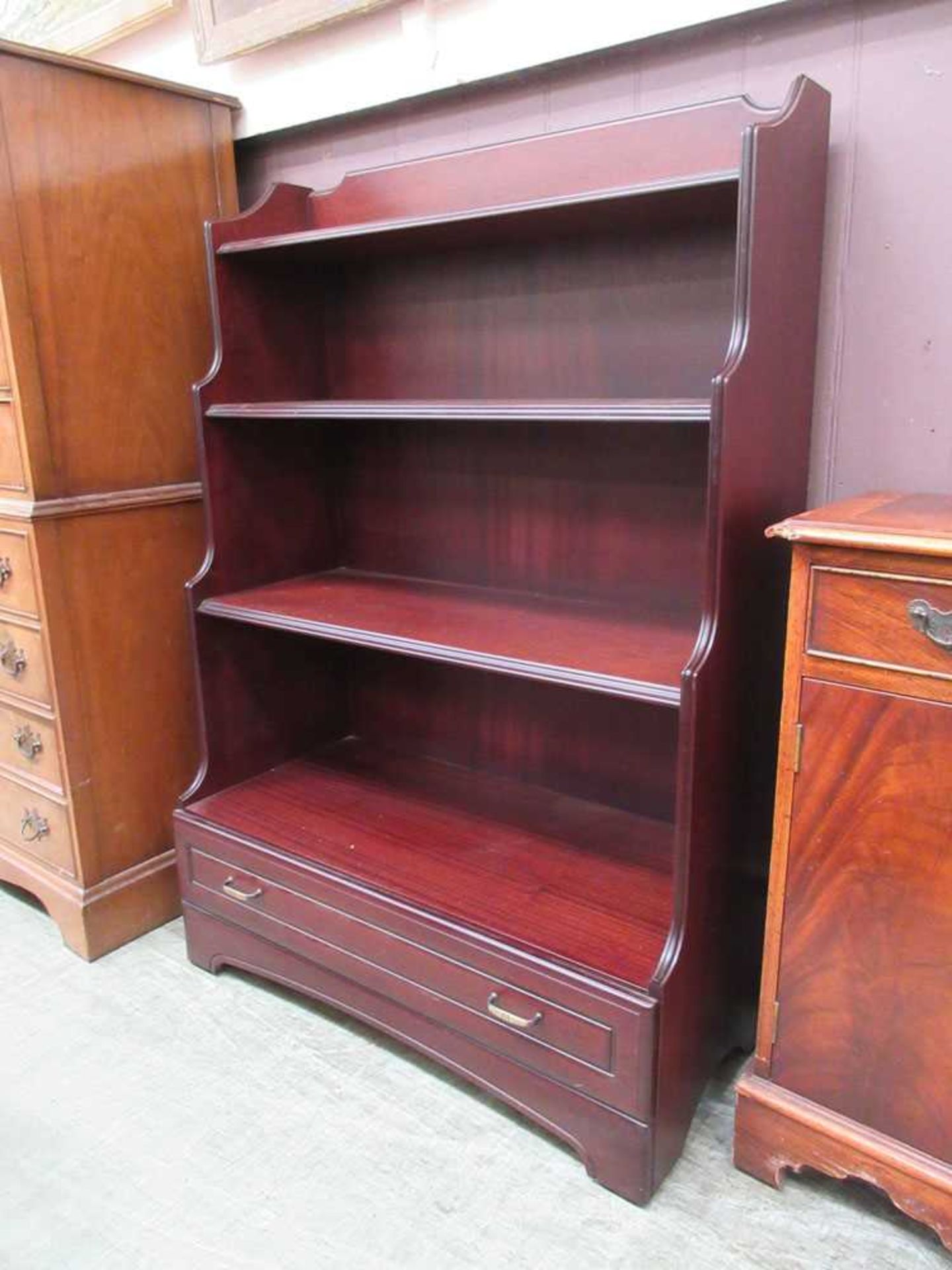 A modern mahogany waterfall bookcase