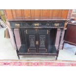 A 19th century ebonized side cabinet, the top over three drawers and two cupboard doors and open