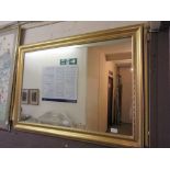 A gilt framed rectangular mirror