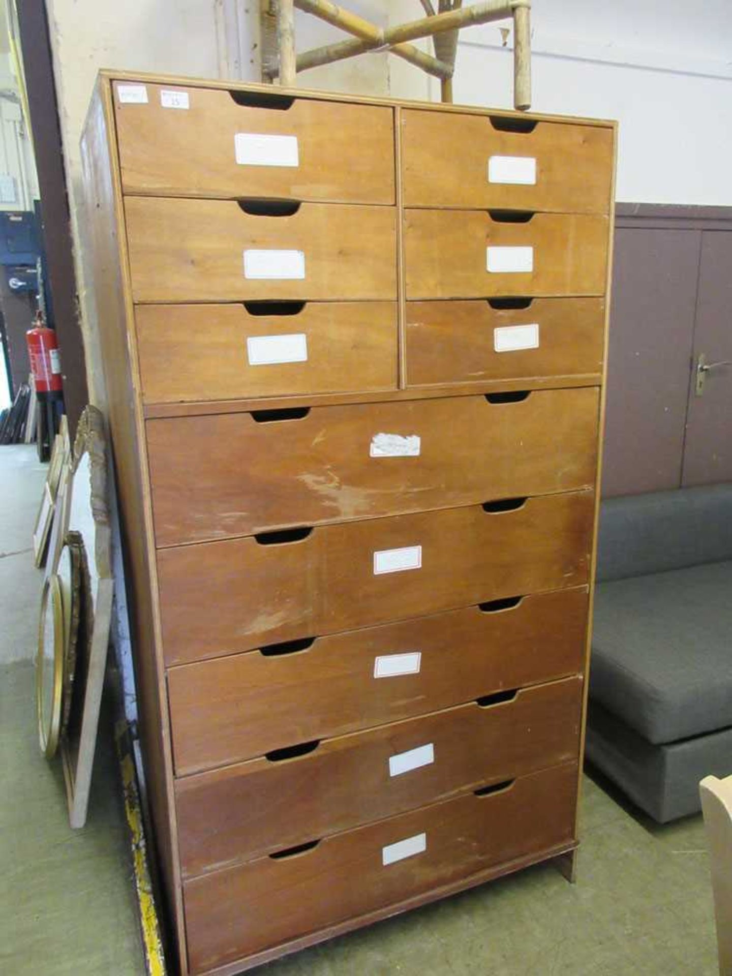 A plywood bank of drawers comprising of six small over five long drawers