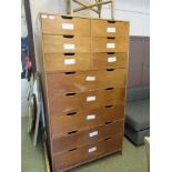 A plywood bank of drawers comprising of six small over five long drawers