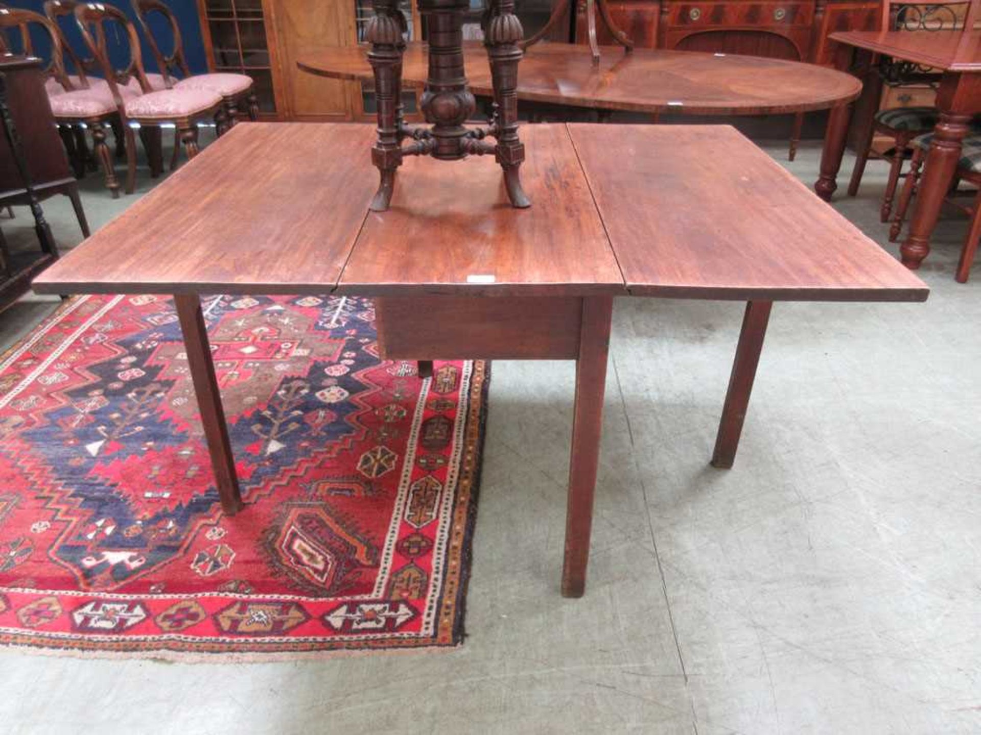 An 18th century Georgian mahogany drop leaf dining table