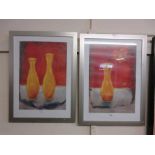 A pair of framed and glazed prints of vases