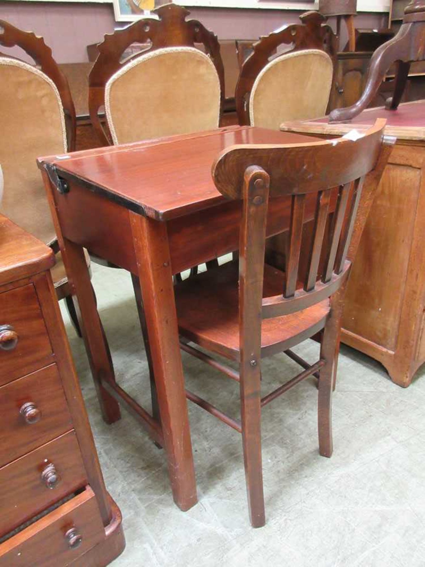 An early 20th century school desk with associated chair