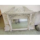 A 19th century white painted over mantle mirror with swan neck pediment over the bevelled glass