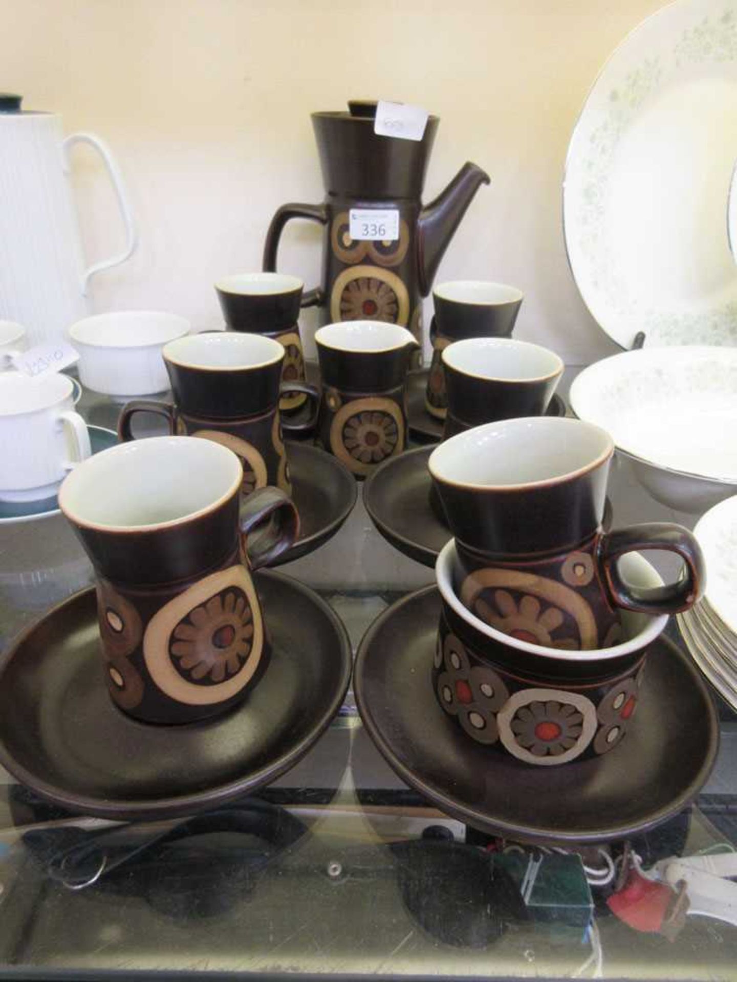 A mid-20th century Denby design brown glazed coffee set comprising of cups, saucers, sugar bowl,