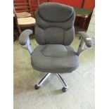 A modern office chair with grey upholstery on five-star base
