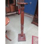 A 19th century carved bed post converted to stand