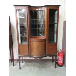 An Edwardian mahogany boxwood strung and marquetry display cabinet, the concave glazed front flanked