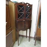 An 18th century mahogany two door cabinet on later stand