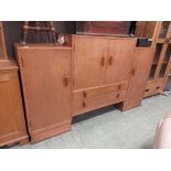 A mid-20th century oak sideboard, the multilevel top over cupboard doors and drawers