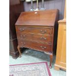 An early 20th century mahogany bureau, the fall front including fitted interior over three long