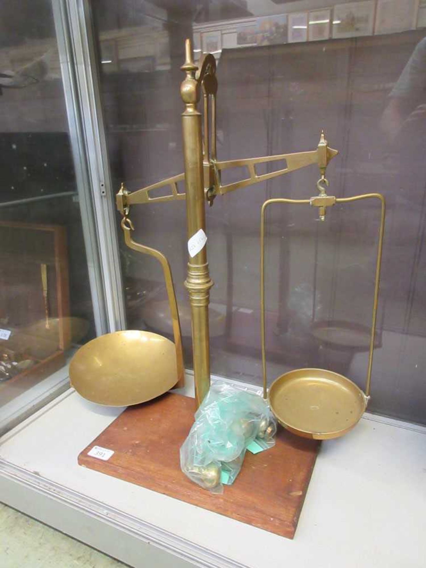 A brass set of balance scales on oak base