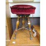 A walnut stool on iron claw feet