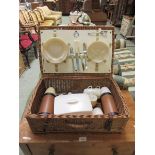 A wicker picnic basket with contents