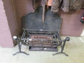 A cast iron fire back along with wrought iron fire grate and dogs