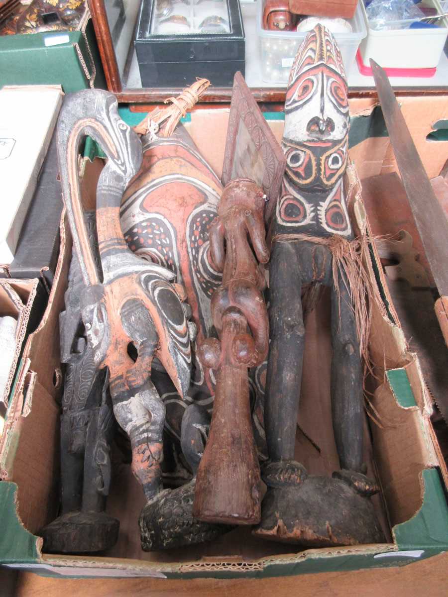 A tray containing a selection of African items to include figures, photo frame, mask, etc