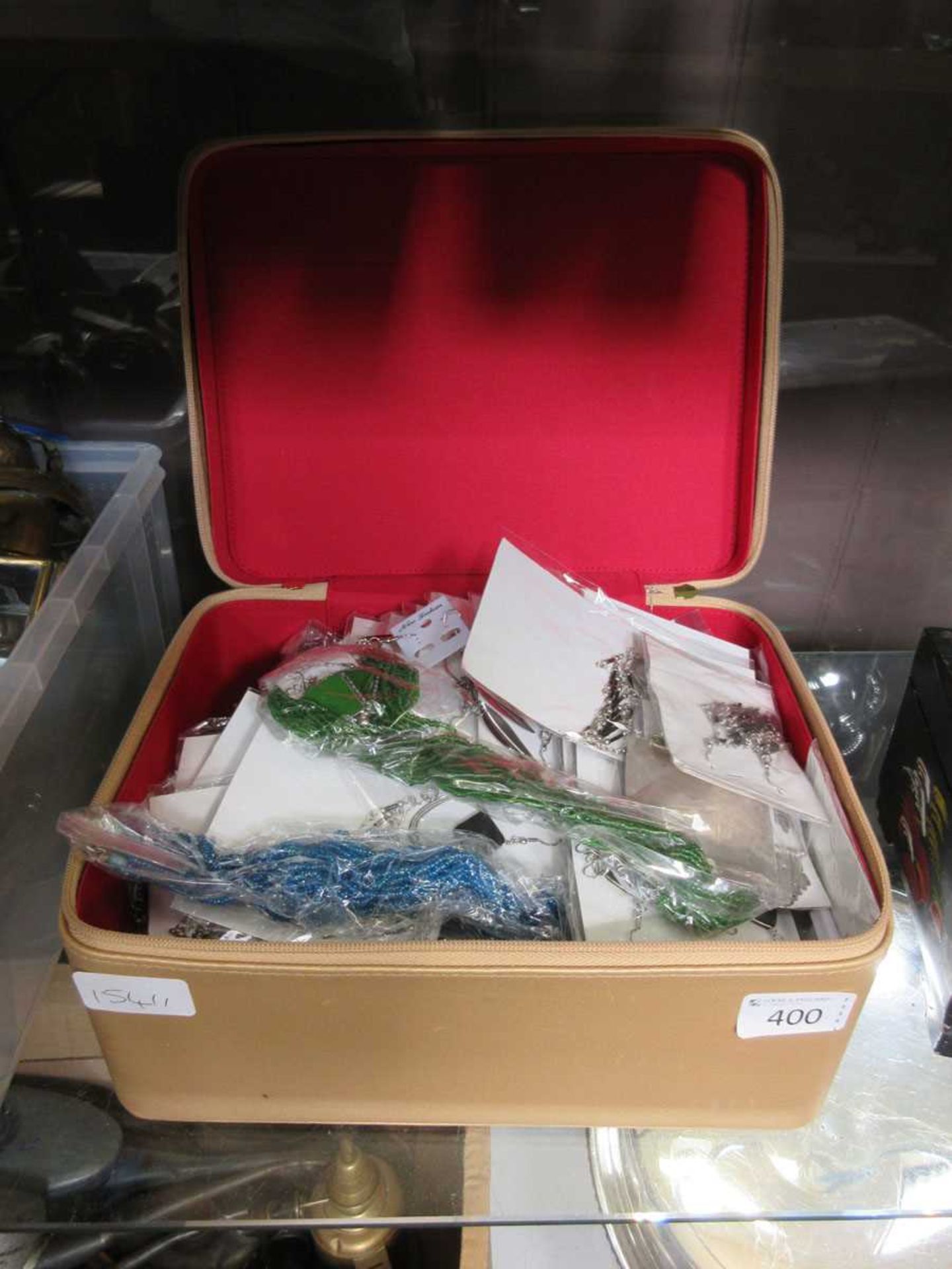 A jewellery box containing a quantity of costume jewellery, necklaces etc.