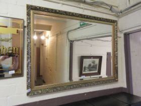 An ornate gilt framed bevel glass mirror