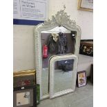 A large 19th century white framed Rococo style mirror along with one matching smaller one