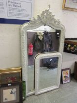A large 19th century white framed Rococo style mirror along with one matching smaller one