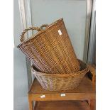 A wicker laundry basket along with a wicker basket