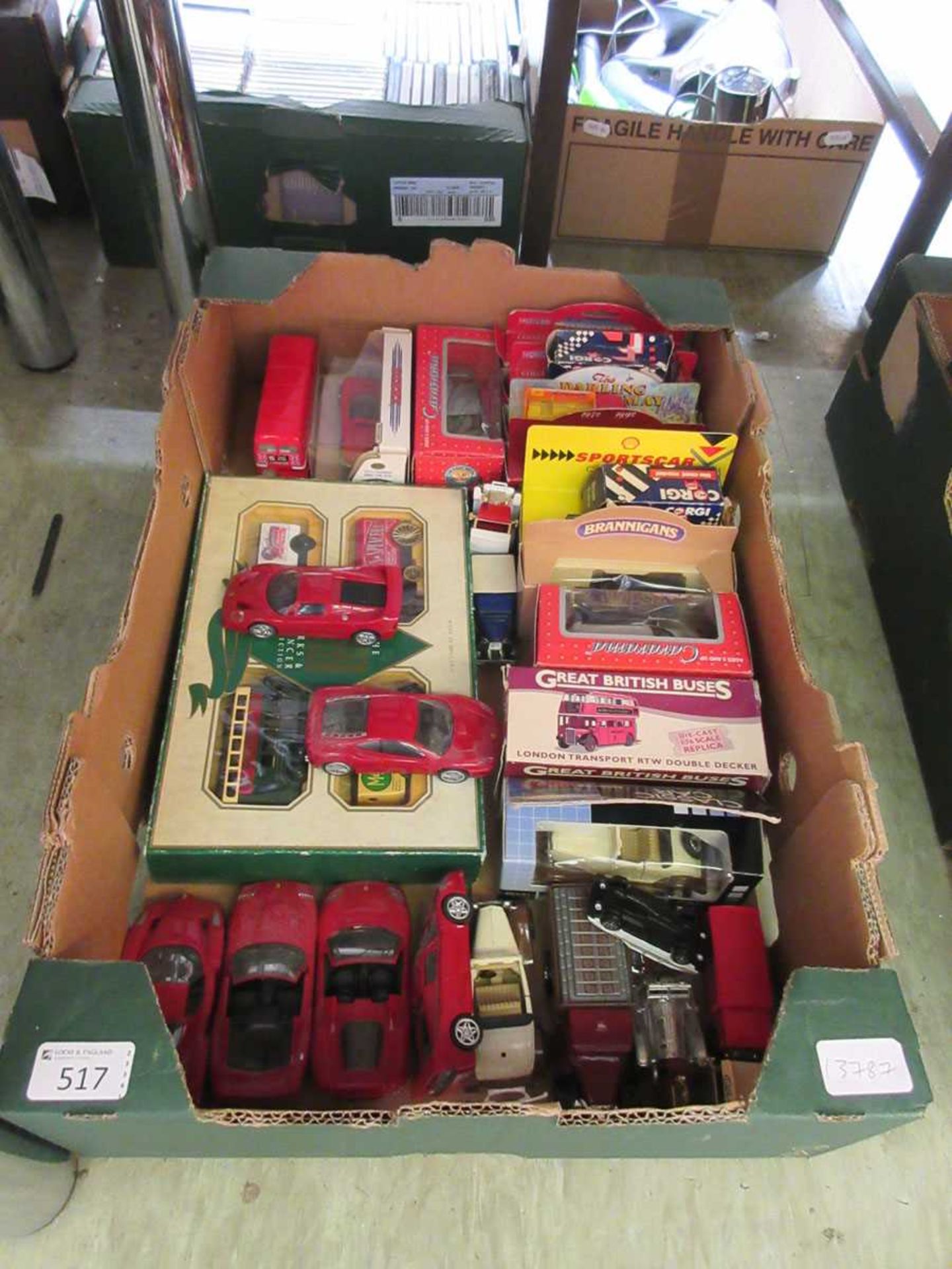 A tray containing a selection of boxed and unboxed die cast vehicles