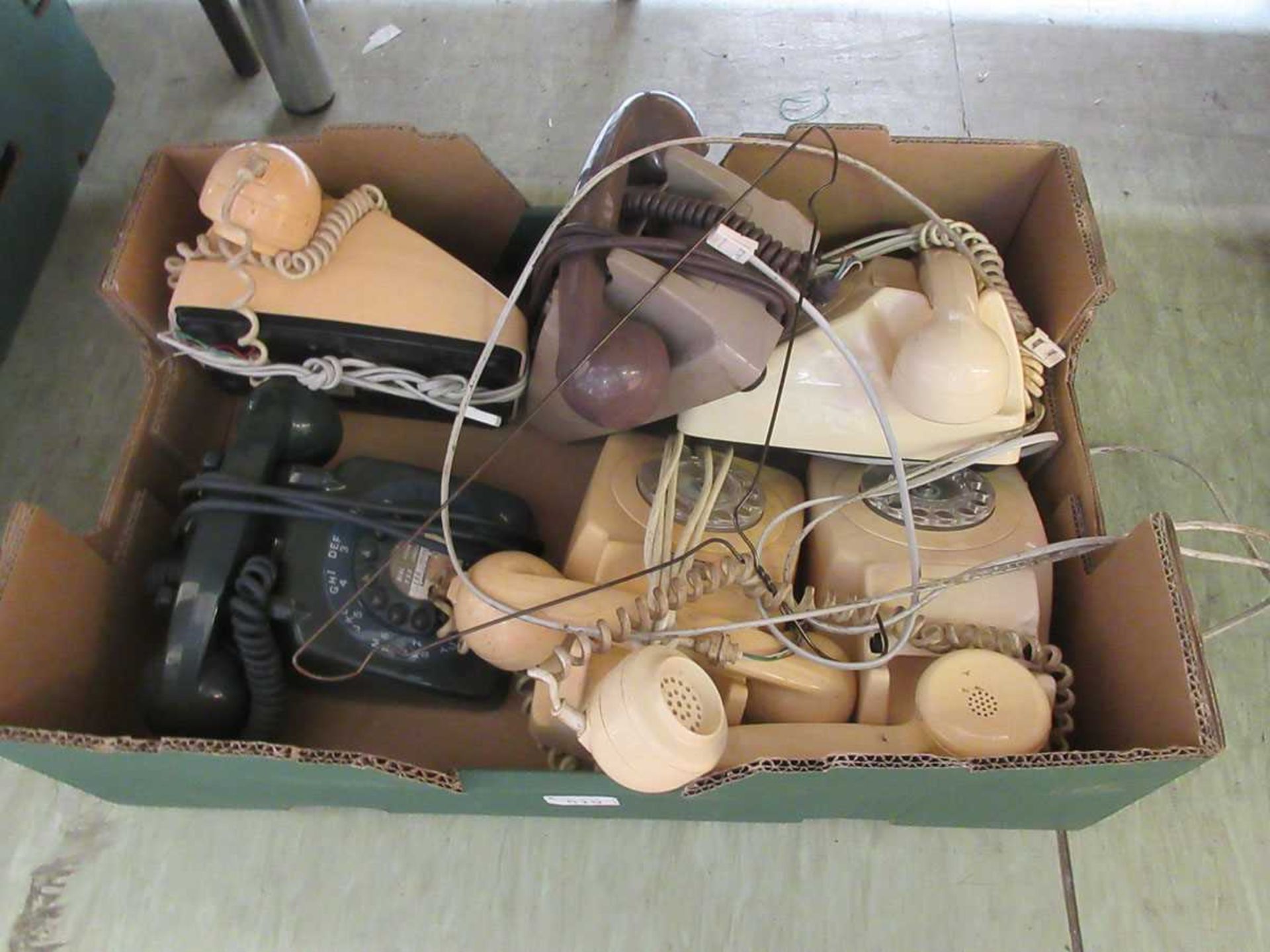 A tray containing six 20th century dial up telephones