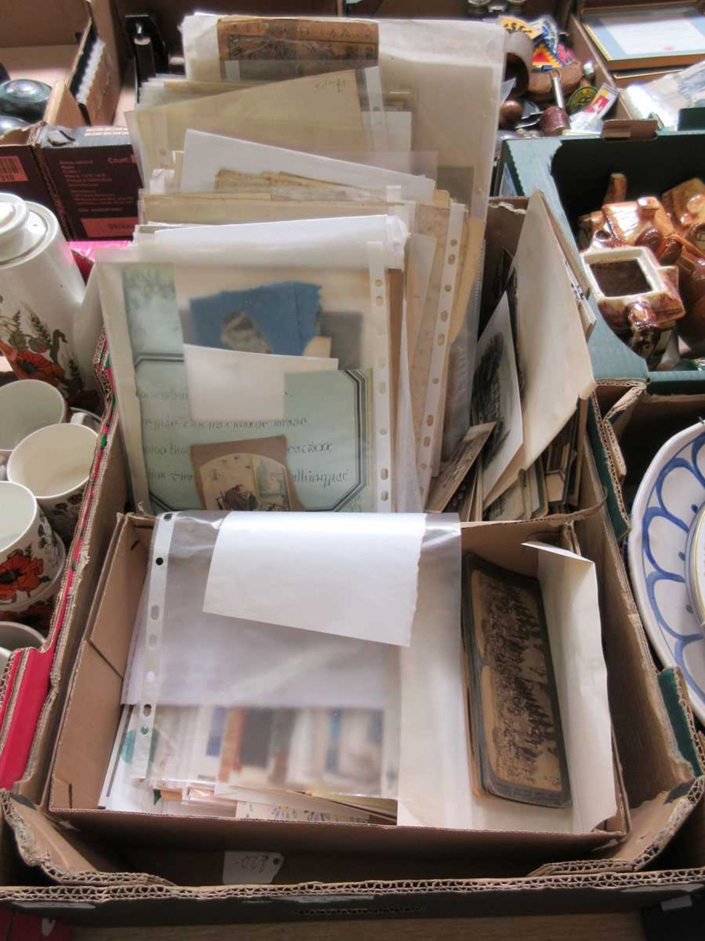 A tray containing an assortment of ephemera to include stereoscopic slides, unframed prints, etc