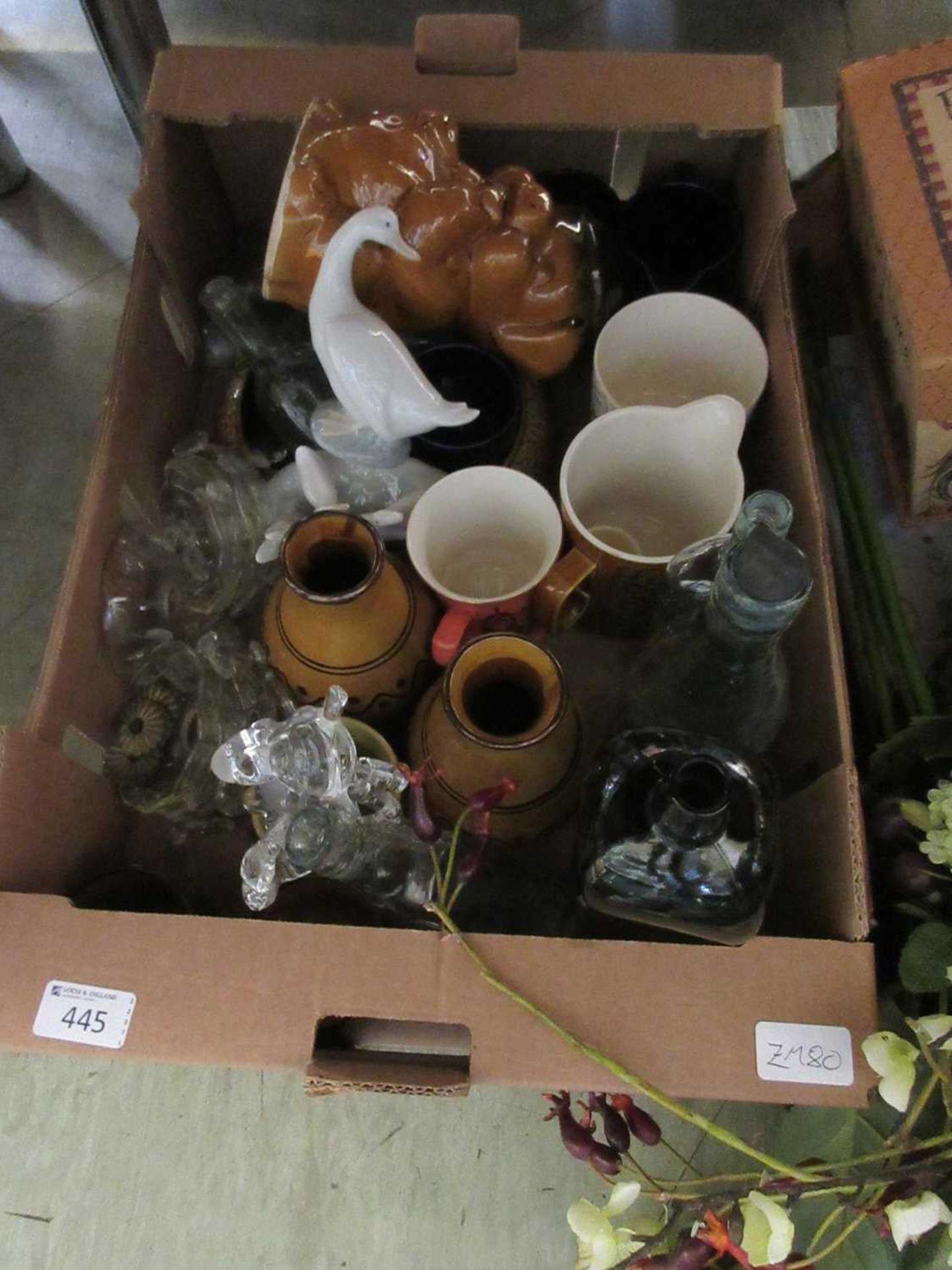 A tray of ceramic and glassware to include Nao geese, glass bottles, etc