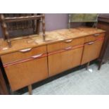 A mid-20th century teak sideboard, the top over three drawers and three cupboard doors (A/F)