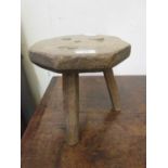 A 19th century elm three-legged milking stool