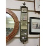 An early 20th century bevel glass rectangular mirror with print to top