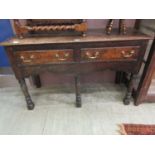 An early 18th century and later oak two drawer sideboard on turned legs Mostly solid, wobbles